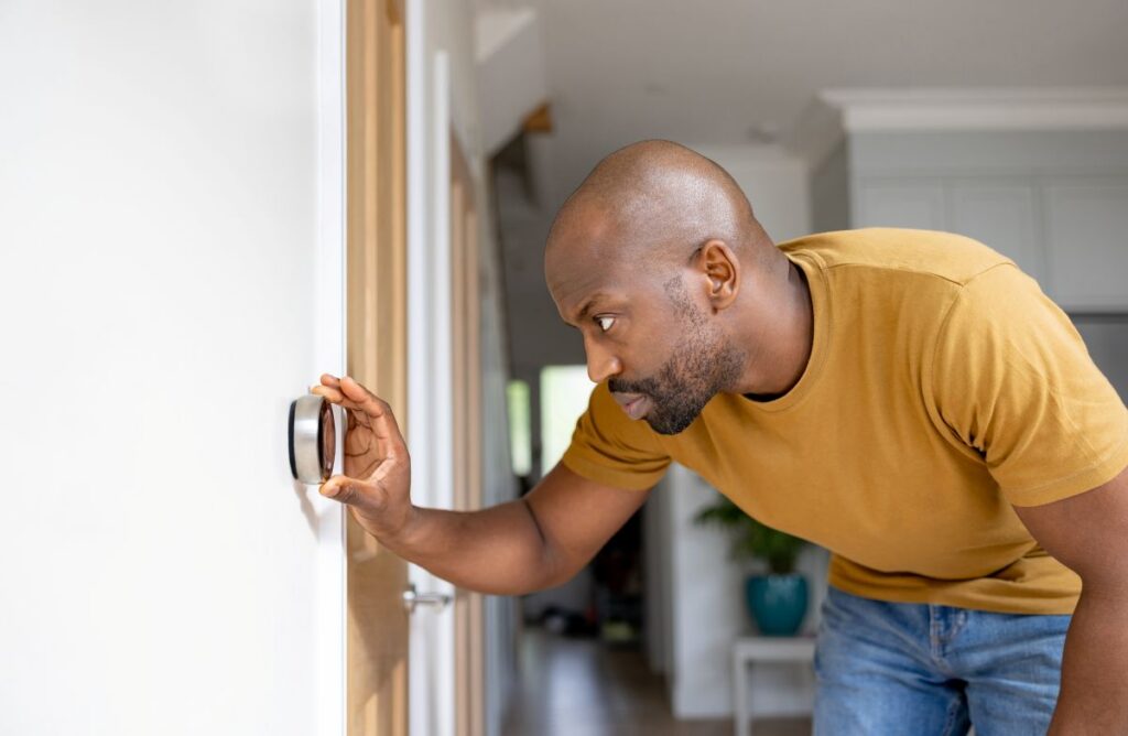 homeowner checking thermostat